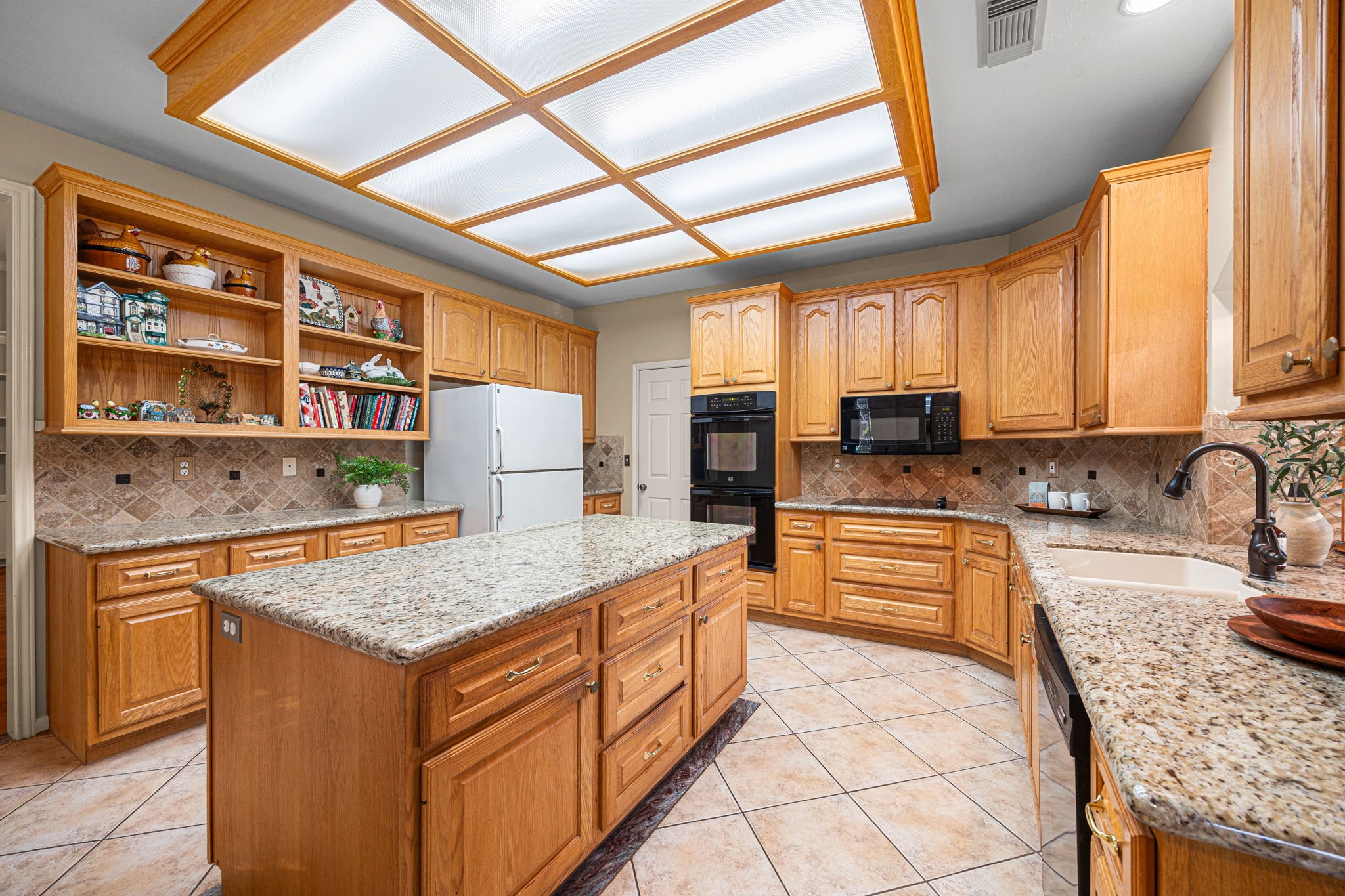 1102 Wood Fern Drive Sugar Land, TX 77479 - Photo 22 of 43 a kitchen with stainless steel appliances granite countertop sink stove and refrigerator