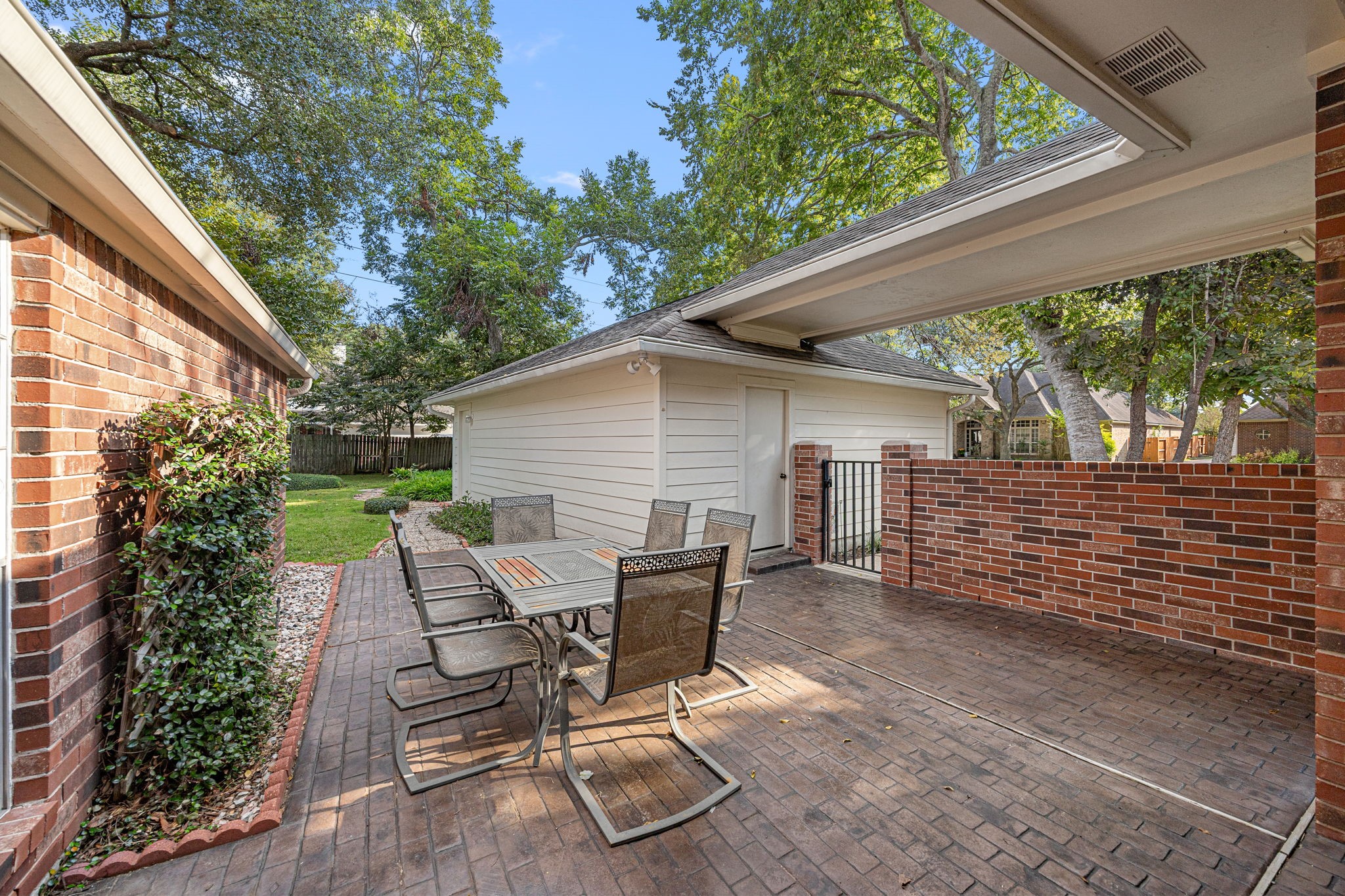 1102 Wood Fern Drive Sugar Land, TX 77479 - Photo 27 of 43 a view of a patio with table and chairs with wooden floor and fence