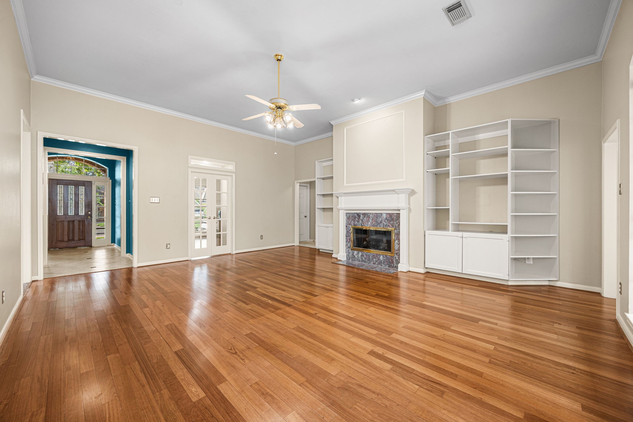 1102 Wood Fern Drive Sugar Land, TX 77479 - Photo 7 of 43 a view of an empty room with wooden floor fireplace and a window