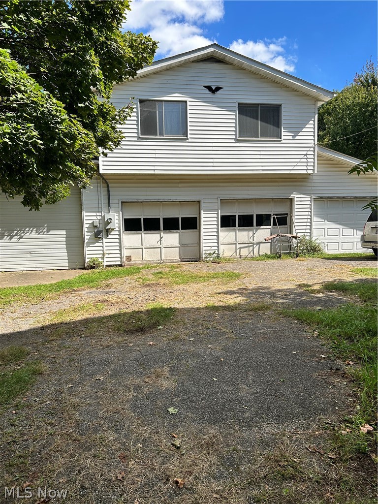 991 Marks Road Brunswick, OH 44212 - Photo 1 of 34 White horizontal siding, two garage doors, two upper-level windows, and a sloped roofline