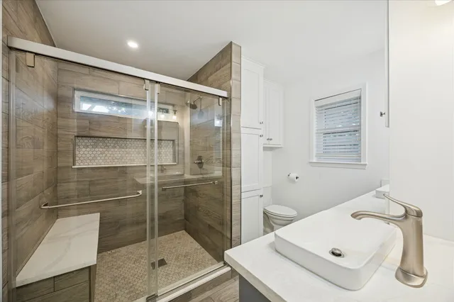 a bathroom with a shower sink and mirror