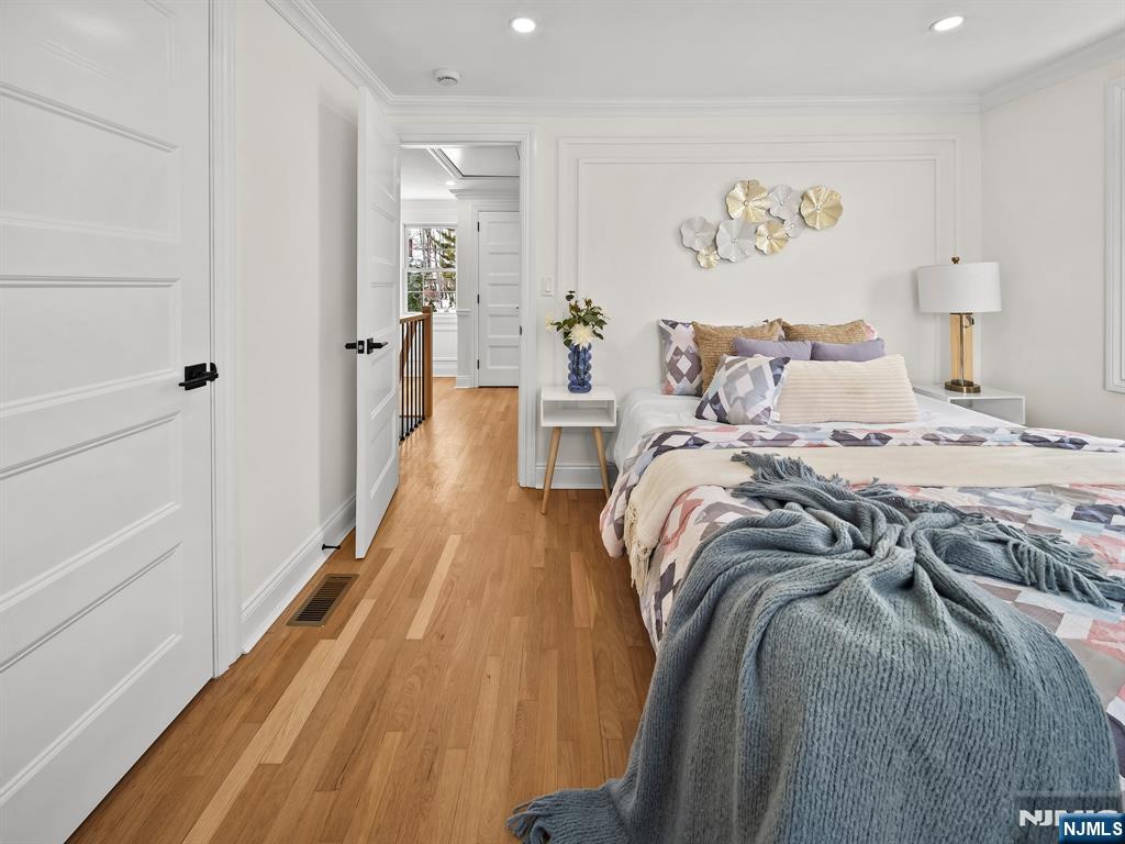 857 Collingwood Avenue Maywood, NJ 07607 - Photo 24 of 30 a bed room with a bed and a painting on the wall