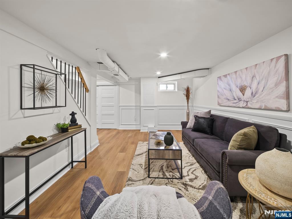 857 Collingwood Avenue Maywood, NJ 07607 - Photo 30 of 30 a living room with furniture and a wooden floor