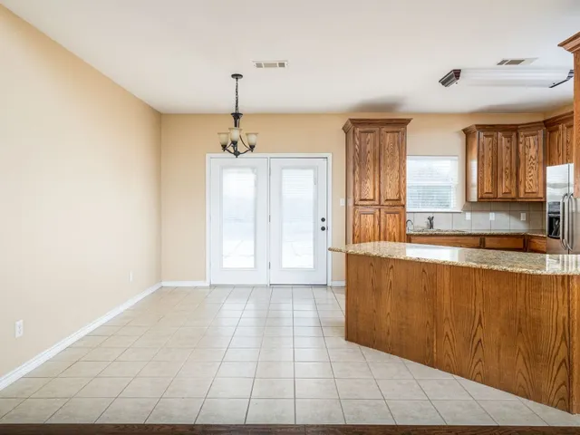 a large bed sitting in a room next to a window