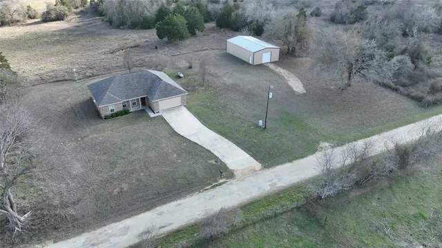 a view of a dry yard with a bench