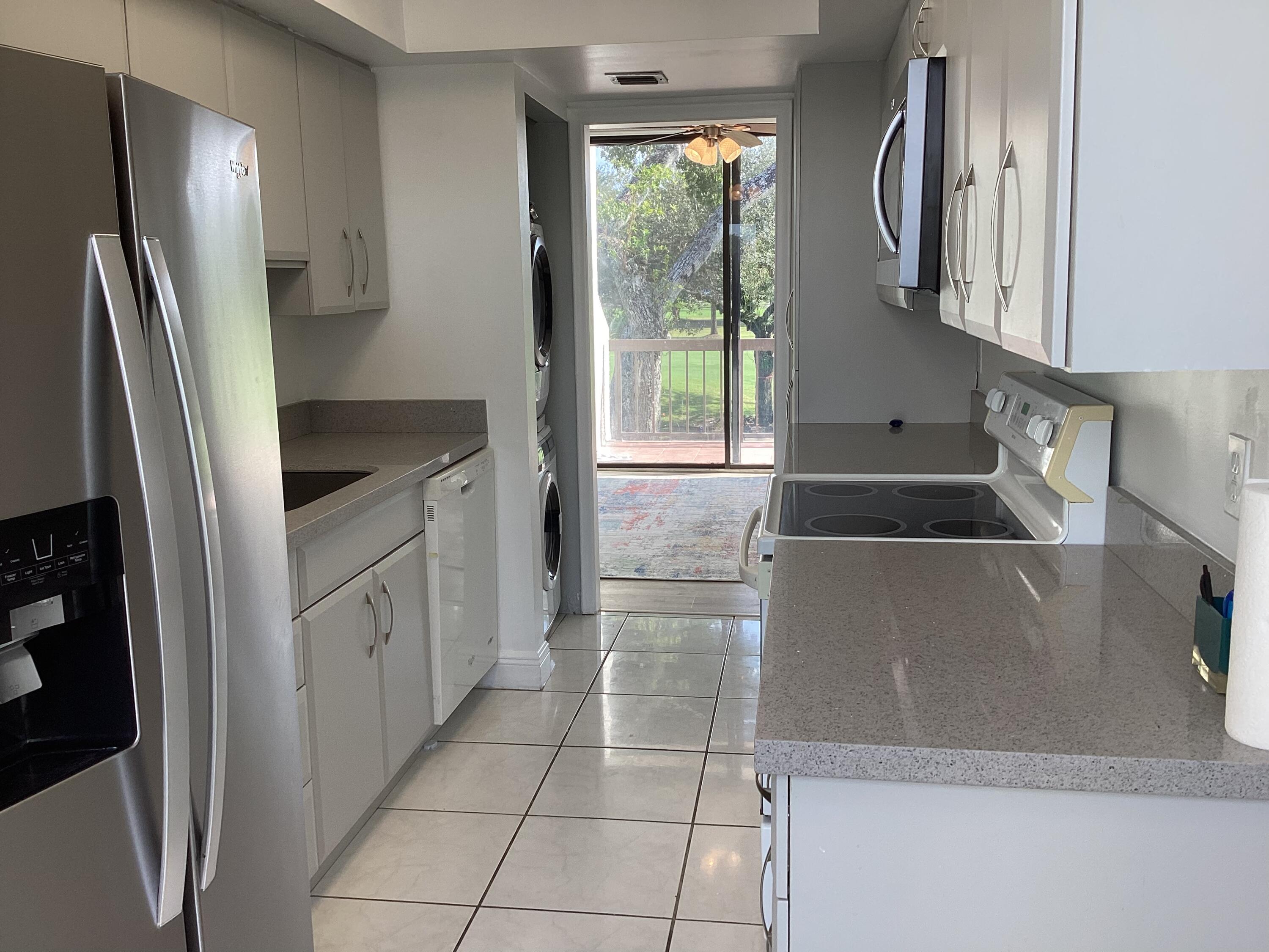 2308 Bridgewood Drive, Unit 2308 Boca Raton, FL 33434 - Photo 15 of 42 a kitchen with stainless steel appliances granite countertop a refrigerator and a sink