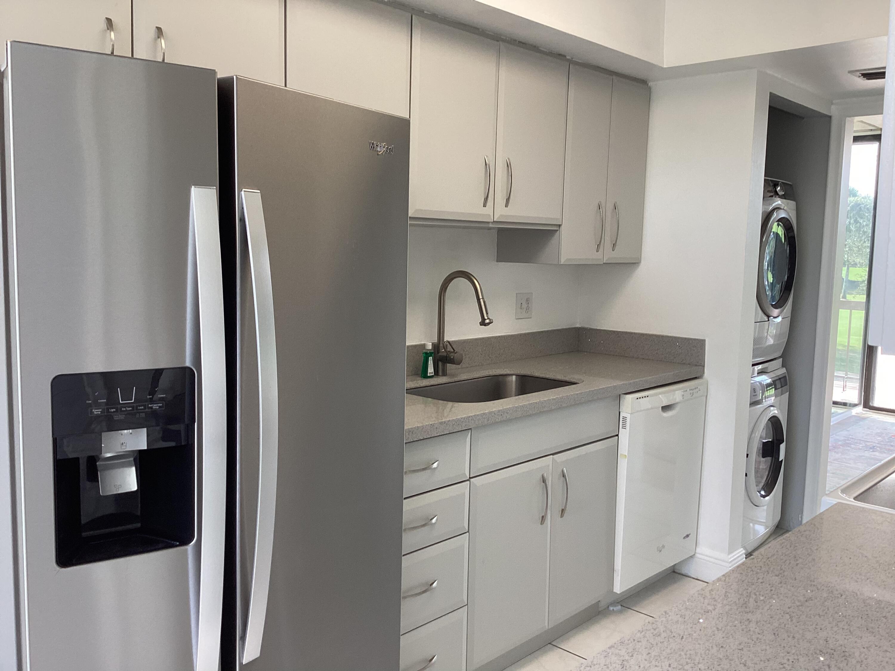 2308 Bridgewood Drive, Unit 2308 Boca Raton, FL 33434 - Photo 16 of 42 a kitchen with stainless steel appliances granite countertop a refrigerator and a sink