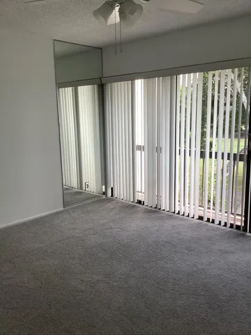 an empty room with windows and stairs