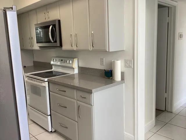 a kitchen with cabinets and stainless steel appliances