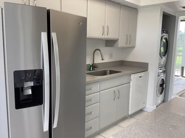 a kitchen with stainless steel appliances granite countertop a refrigerator and a stove