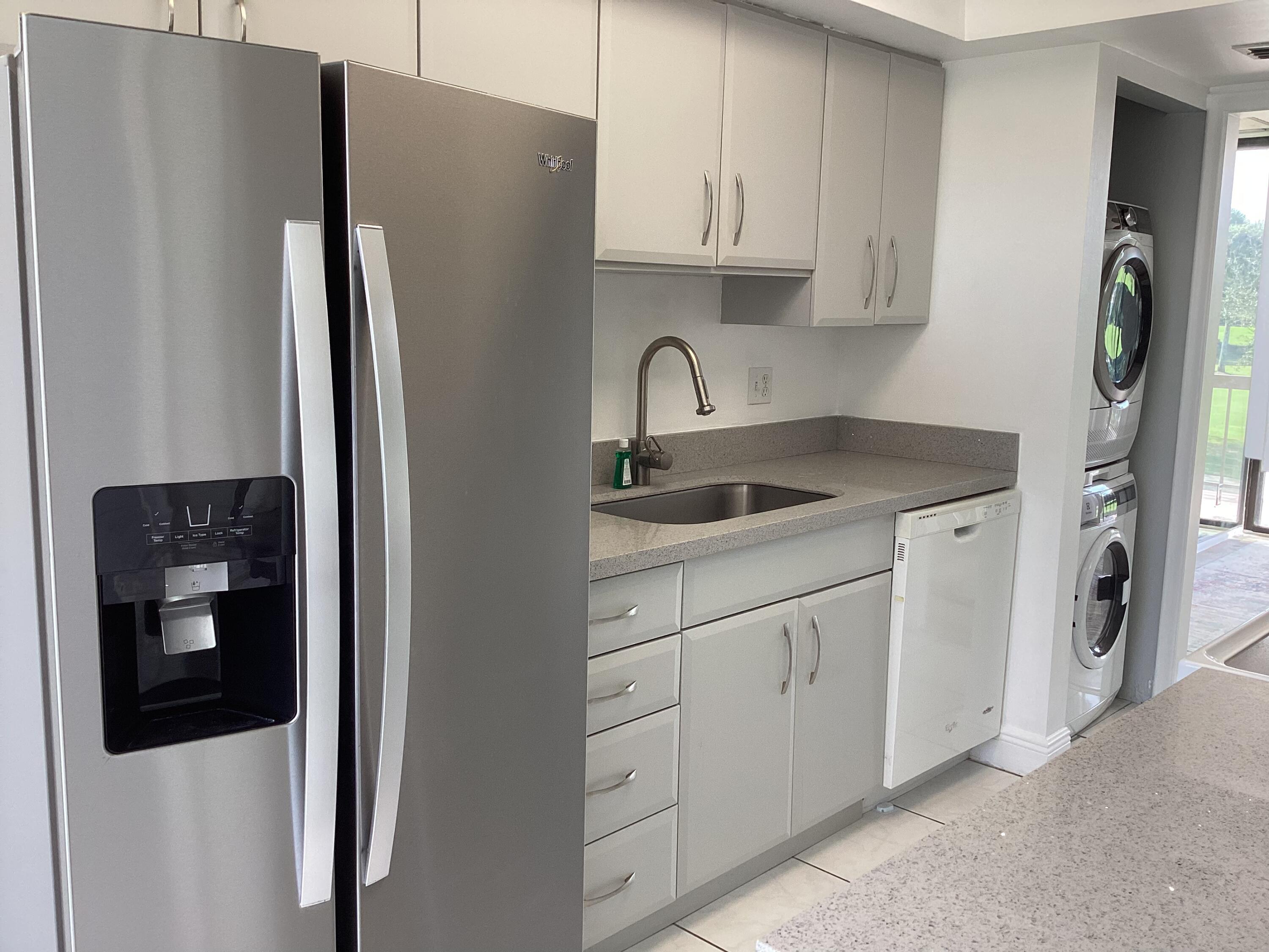 2308 Bridgewood Drive, Unit 2308 Boca Raton, FL 33434 - Photo 19 of 42 a kitchen with stainless steel appliances granite countertop a refrigerator and a stove