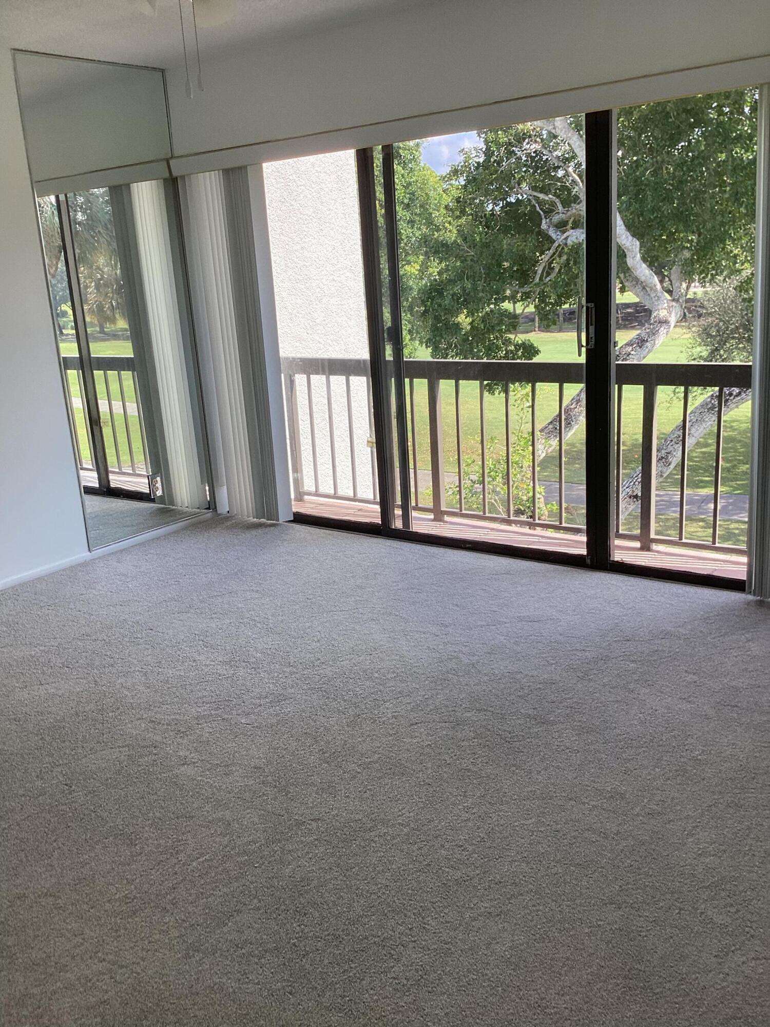 2308 Bridgewood Drive, Unit 2308 Boca Raton, FL 33434 - Photo 21 of 42 a view of an empty room with a large window