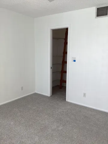 a view of an empty room and closet