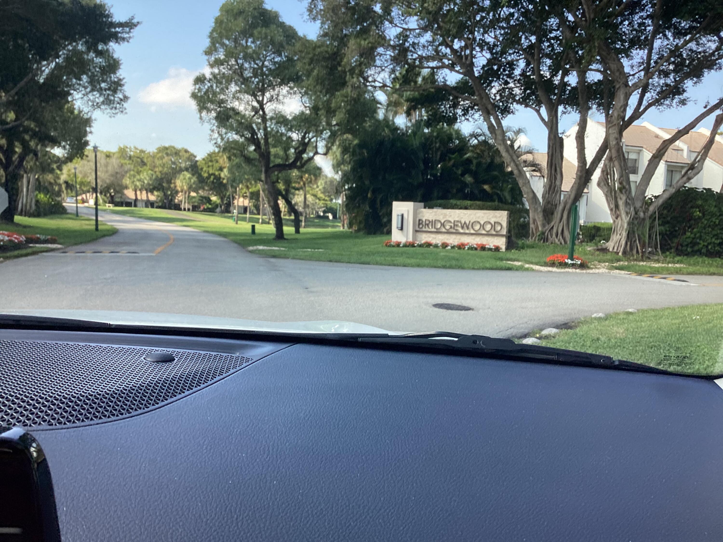 2308 Bridgewood Drive, Unit 2308 Boca Raton, FL 33434 - Photo 3 of 42 a view of a street with a large trees