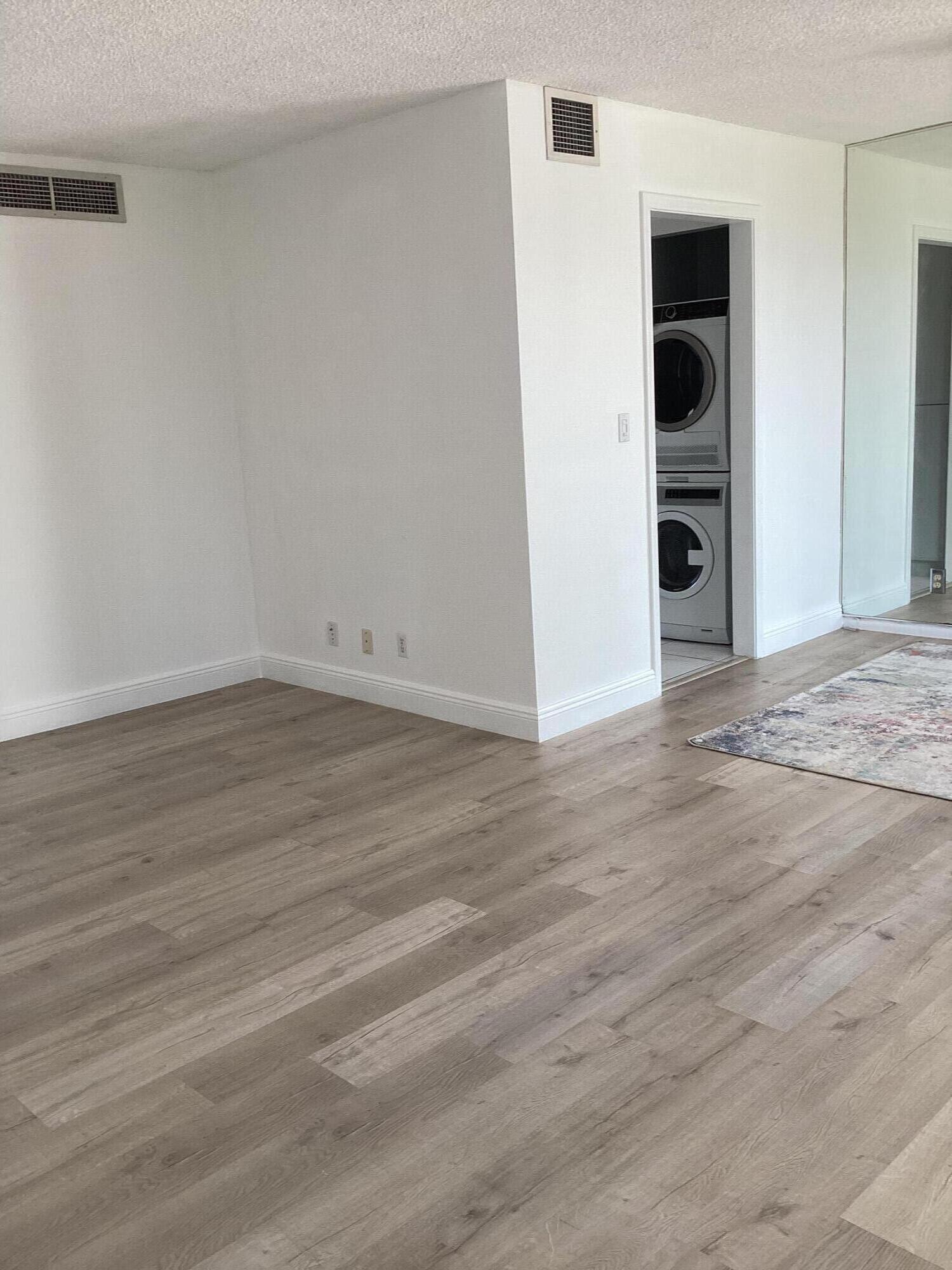 2308 Bridgewood Drive, Unit 2308 Boca Raton, FL 33434 - Photo 35 of 42 an empty room with wooden floor and closet