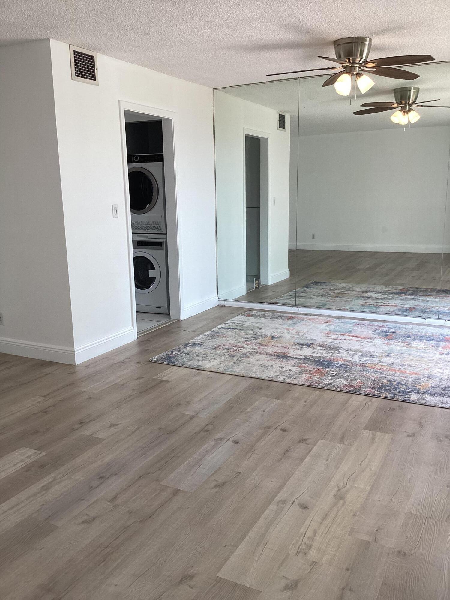 2308 Bridgewood Drive, Unit 2308 Boca Raton, FL 33434 - Photo 6 of 42 a view of a big room with wooden floor and ceiling fan