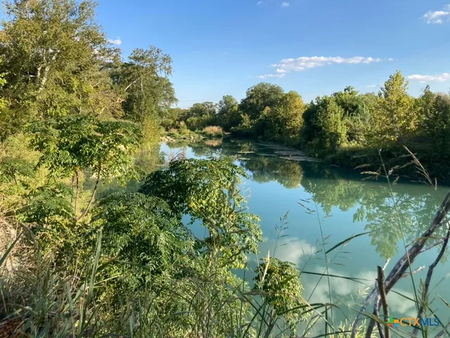 a view of a lake with a house in the background