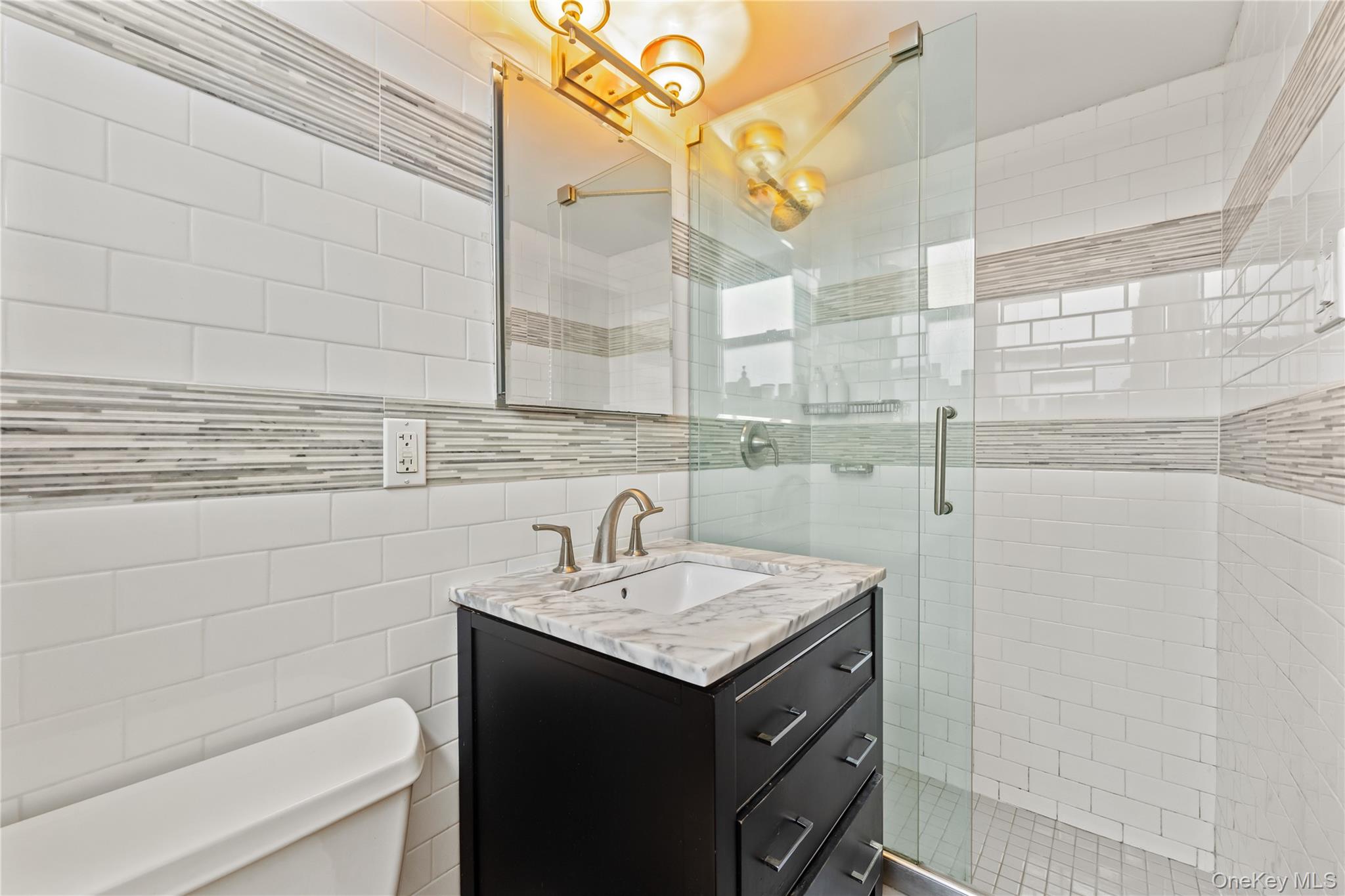 61-15 97th Street, Unit 10A Queens, NY 11374 - Photo 12 of 21 Bathroom with vanity, a shower stall, and tile walls