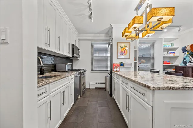 a kitchen with stainless steel appliances granite countertop a sink and cabinets