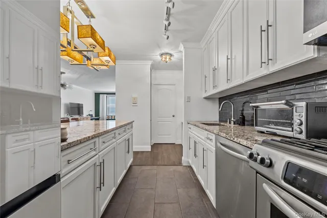 a kitchen with stainless steel appliances granite countertop a stove and a refrigerator