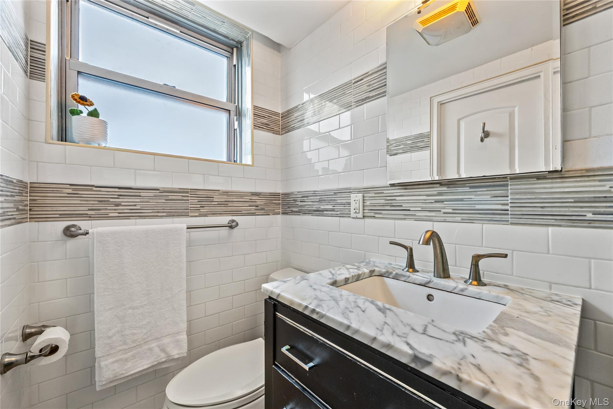 61-15 97th Street, Unit 10A Queens, NY 11374 - Photo 10 of 21 Bathroom featuring vanity, tile walls, and backsplash