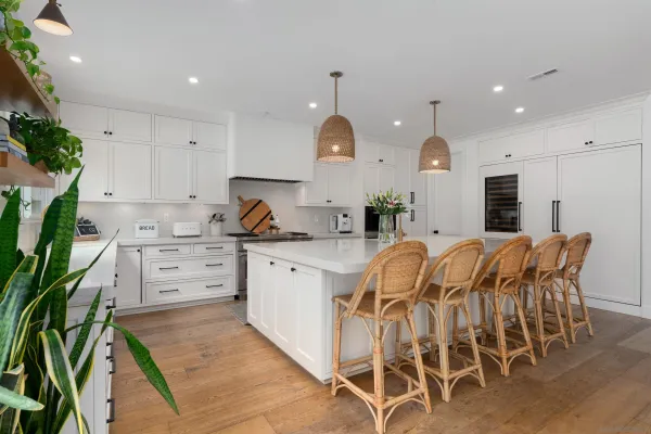 a kitchen with appliances cabinets and chair