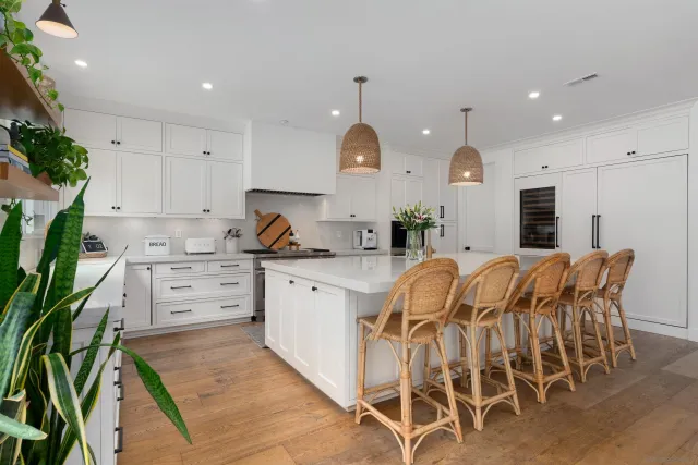 a kitchen with appliances cabinets and chair