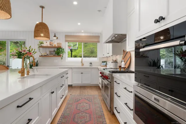 a kitchen with a sink stove and cabinets