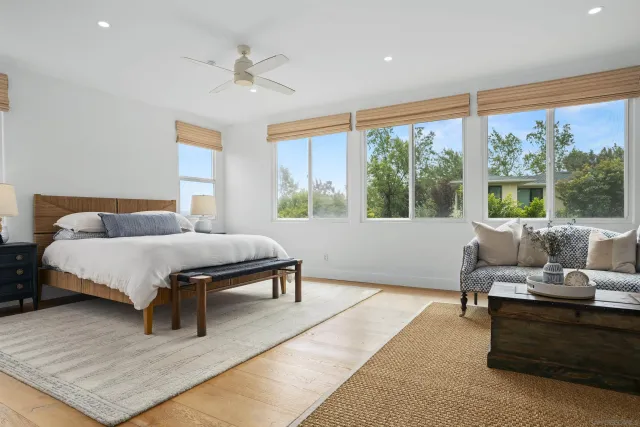 a bedroom with a bed and a large window