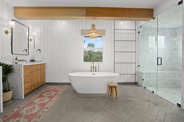 a bathroom with a sink mirror and a bathtub