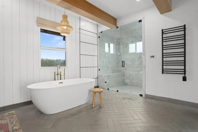a bathroom with a bathtub and shower