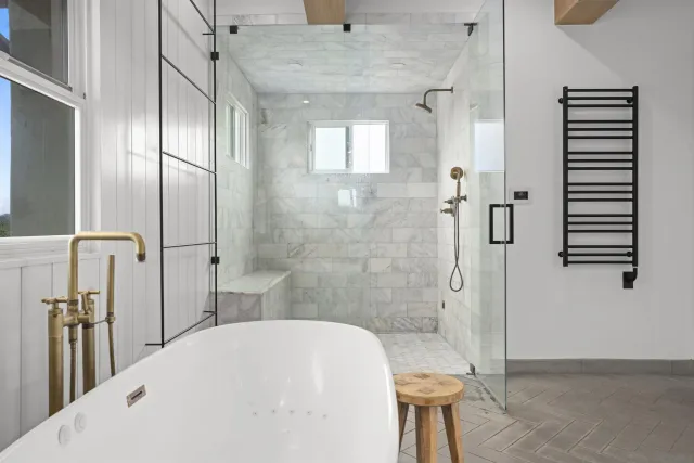 a bathroom with a bathtub and shower
