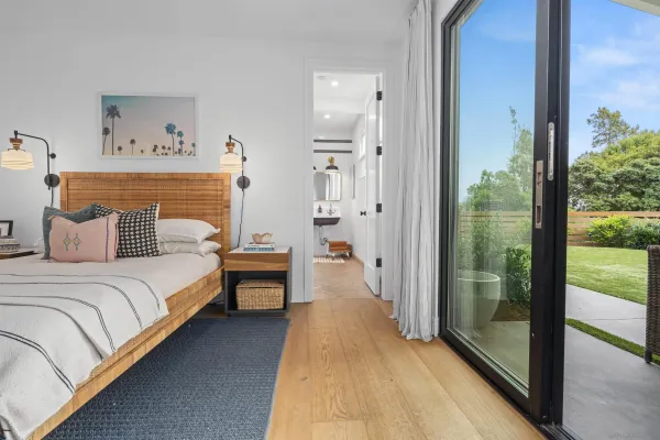 a bedroom with a bed and large window