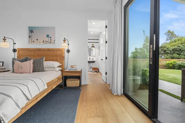 a bedroom with a bed and large window