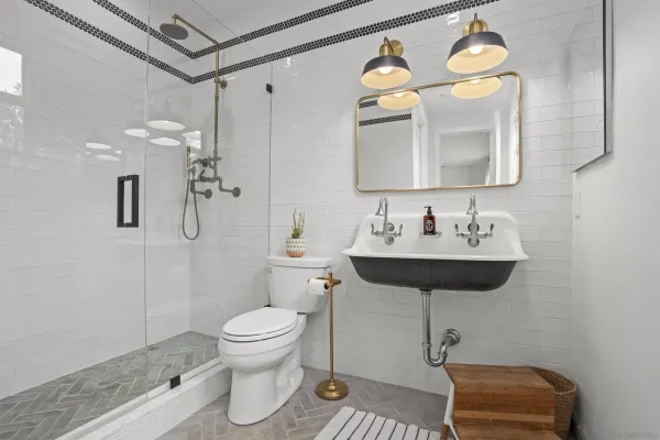 a bathroom with a toilet sink and mirror
