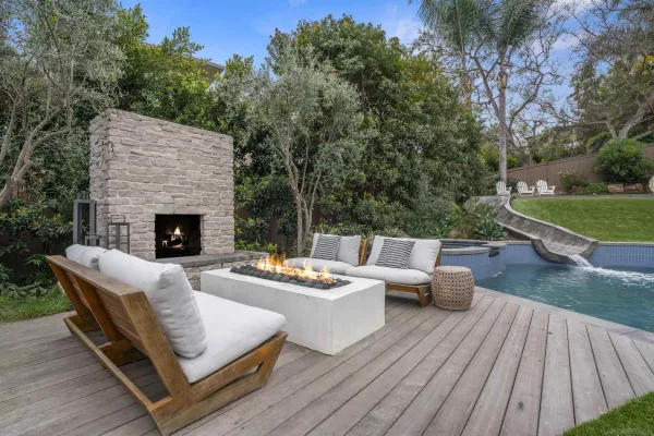 a outdoor space with patio the couches and a fireplace