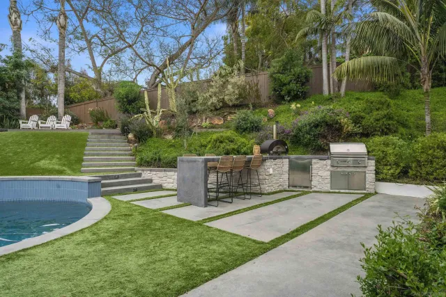 a view of a chair and table in the garden