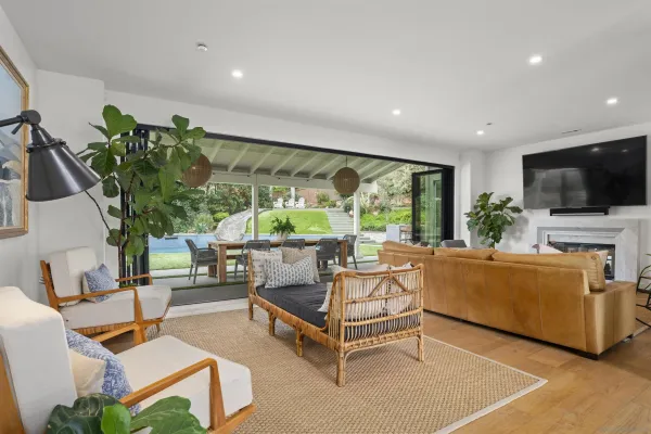 a living room with furniture a flat screen tv and a large window