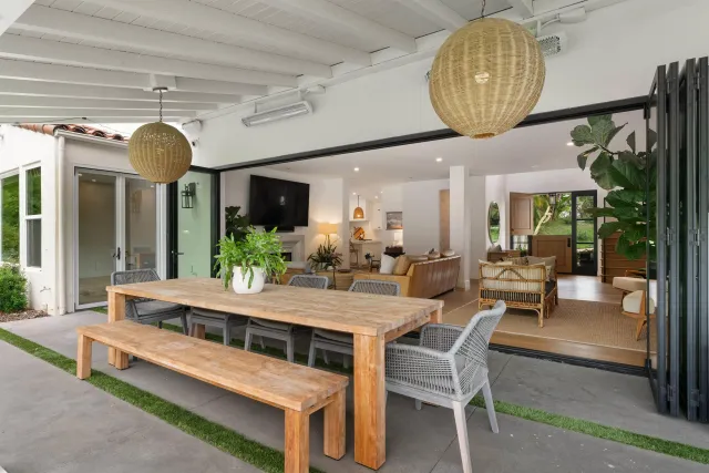 a view of a dining room with furniture wooden floor and chandelier