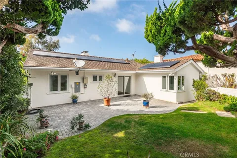 a view of a house with backyard sitting area and garden
