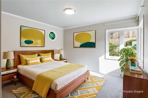 a bedroom with a bed and a potted plant