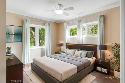 a bedroom with a large bed and a potted plant