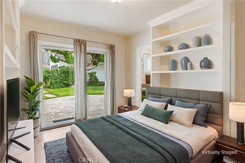 a bed sitting in a bedroom next to a window