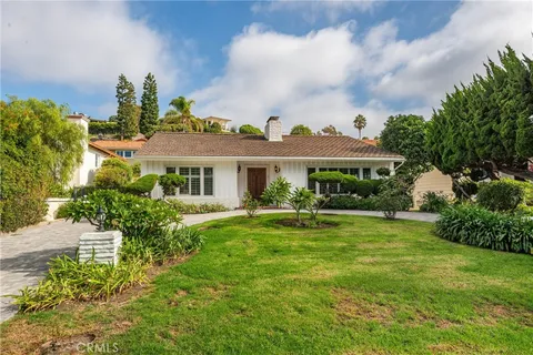 a front view of a house with garden and porch