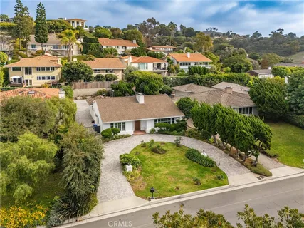 an aerial view of residential houses with outdoor space and river