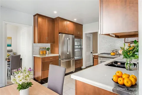 a kitchen with stainless steel appliances a refrigerator and a stove