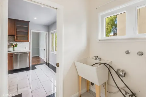 a view of a hallway with furniture and a window