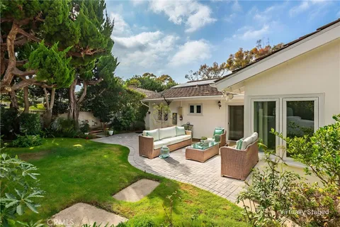 a view of a house with backyard sitting area and garden