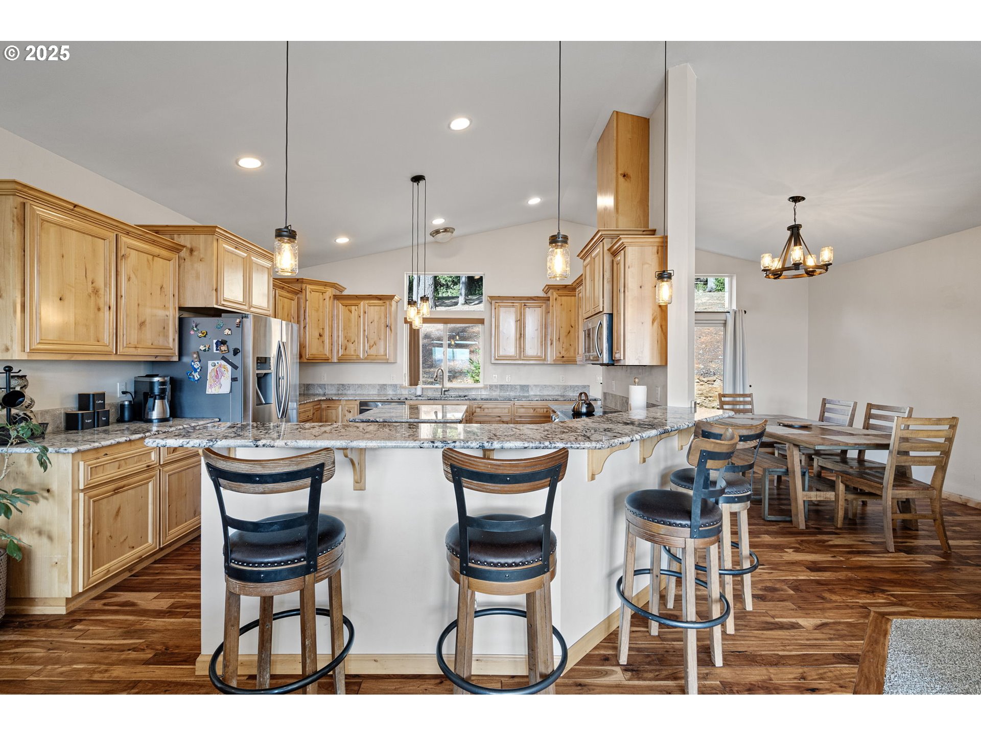 24674 Bolton Hill Road Veneta, OR 97487 - Photo 15 of 48 a dining hall with stainless steel appliances kitchen island granite countertop a table and chairs