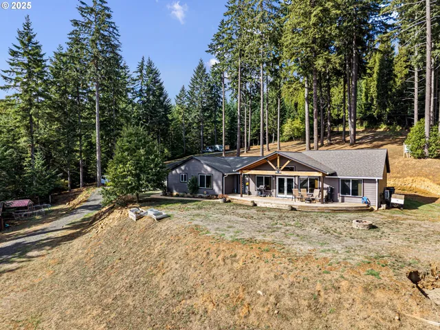 a white house that has a tree in front of it